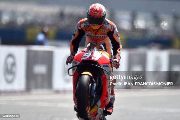 Repsol Honda Team's Spanish rider Marc Marquez crosses the finish line after winning the MotoGP race, of the French motorcycling Grand Prix, on May...