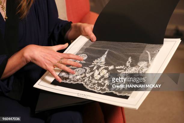 Clare Waight Keller, a fashion designer at Givenchy, holds a sample of lace during an interview at Kensington Palace in London on May 20 the day...