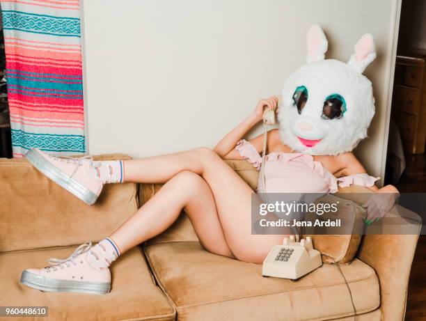 funny retro woman talking on telephone wearing bunny mask - rabbit mask stockfoto's en -beelden