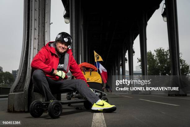 French Fabrice Gropaiz poses during a photo session with his electric skateboard at the Pont de Bir-Hakeim bridge in Paris on May 15, 2018. - Twenty...