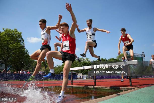 Ciaran Lewis of Wales and Daniel Jarvis of England clear the water jump alongside each other during the Men's 3000m Steeple Chase at the Loughborough...