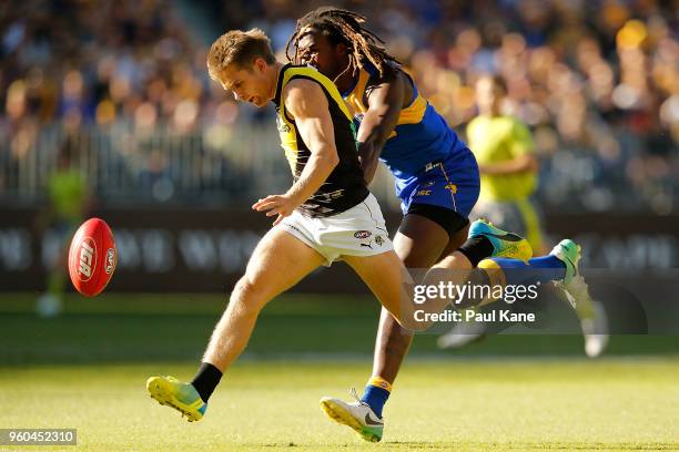 Dan Butler of the Tigers passes the ball during the round nine AFL match between the West Coast Eagles and the Richmond Tigers at Optus Stadium on...