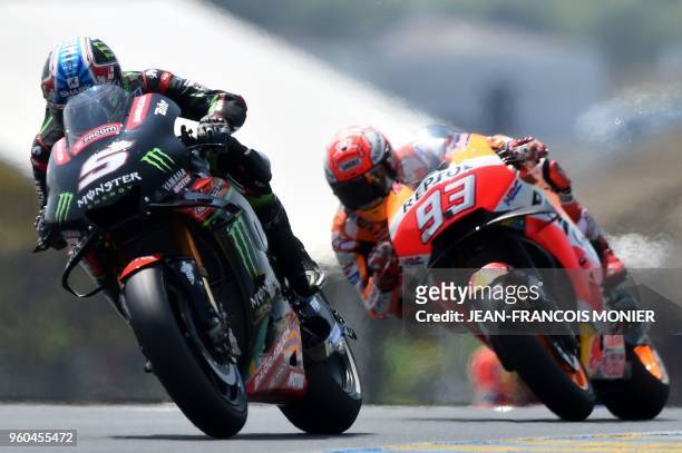 Monster Yamaha Tech 3's French rider Johann Zarco and Repsol Honda Team's Spanish rider Marc Marquez compete during the MotoGP race, of the French...