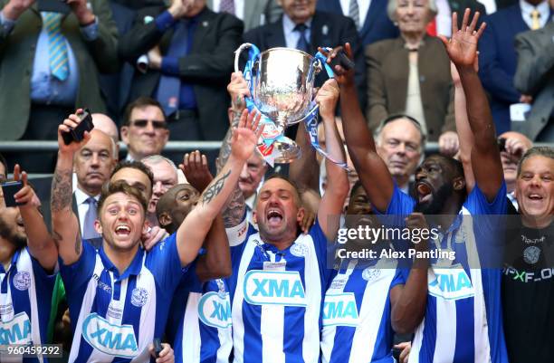 Tom Melledew of Thatcham Town lifts the trophy following victory during the Buildbase FA Vase Final between Stockton Town and Thatcham Town at...