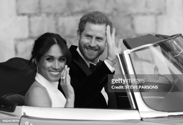 Britain's Prince Harry, Duke of Sussex, and Meghan Markle, Duchess of Sussex, leave Windsor Castle in Windsor on May 19, 2018 in an E-Type Jaguar...