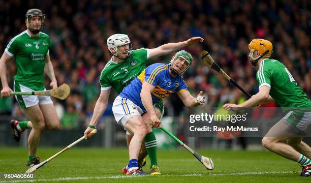 Limerick , Ireland - 20 May 2018; John O'Dwyer of Tipperary hand passes under pressure from Limerick defenders Seamus Hickey and Richie English...