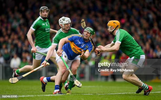 Limerick , Ireland - 20 May 2018; John O'Dwyer of Tipperary hand passes under pressure from Limerick defenders Seamus Hickey and Richie English...