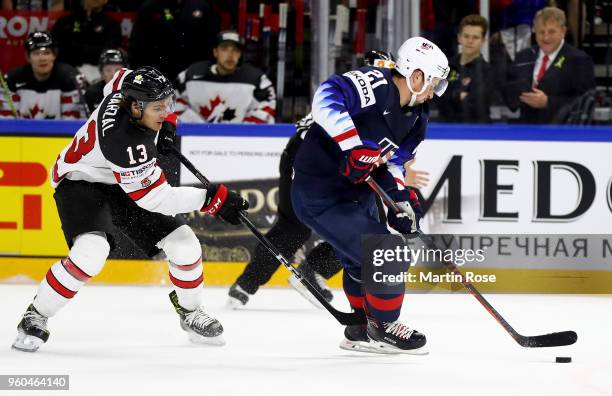 Dylan Larkin of the United States and Matt Barzal of Canada battle for the puck during the 2018 IIHF Ice Hockey World Championship Bronze Medal Game...