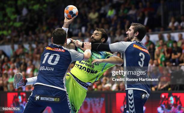 Daniel Sarmiento of Saint-Raphael is attacked by Jakov Gojun and Fabian Wiede of Fuechse Berlin during the Ottostadt Magdeburg EHF Cup Final Four...