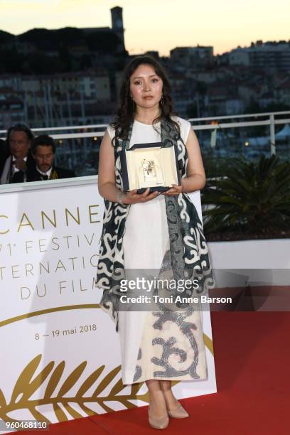 Actress Samal Yeslyamova poses with the Best Actress award for her role in 'Ayka' at the photocall the Palme D'Or Winner during the 71st annual...