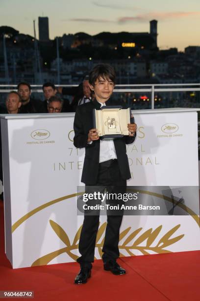 Actor Zain Alrafeea poses with Director Nadine Labaki's Jury Prize award for 'Capharnaum' at the Palme D'Or Winner Photocall during the 71st annual...