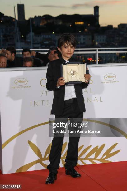 Actor Zain Alrafeea poses with Director Nadine Labaki's Jury Prize award for 'Capharnaum' at the Palme D'Or Winner Photocall during the 71st annual...