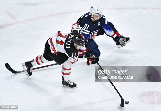 Canada's Jean-Gabriel Pageau vies with United State's Dylan Larkin during the bronze medal match USA vs Canada of the 2018 IIHF Ice Hockey World...