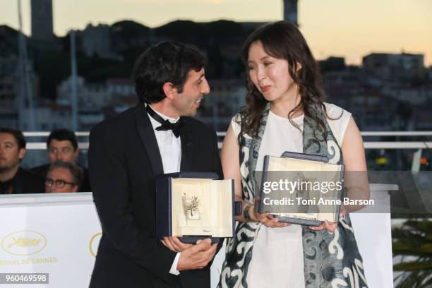 Actress Samal Yeslyamova poses with the Best Actress award for her role in 'Ayka' and actor Marcello Fonte poses with the Best Actor award for his...