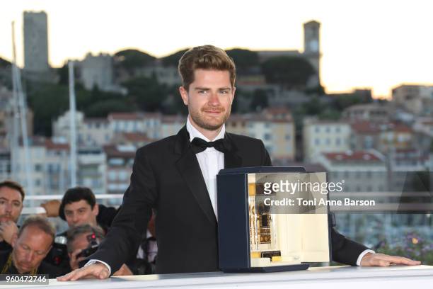 Director of 'Girl' Lukas Dhont poses with the Best Director Camera d'Or jury award at the Palme D'Or Winner Photocal during the 71st annual Cannes...
