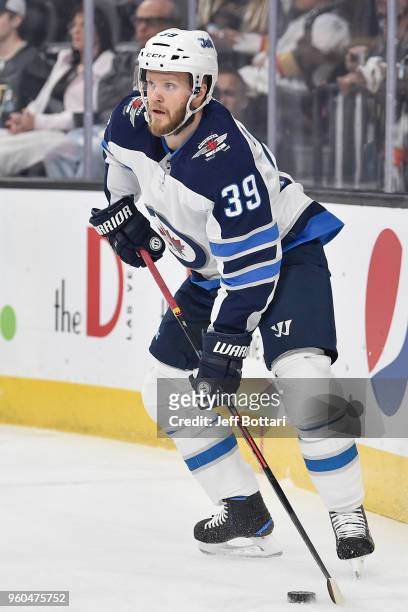 Toby Enstrom of the Winnipeg Jets handles the puck against the Vegas Golden Knights in Game Four of the Western Conference Final during the 2018 NHL...