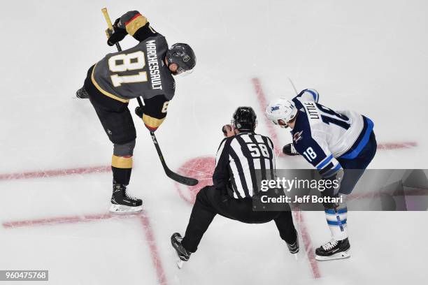 Jonathan Marchessault of the Vegas Golden Knights takes a faceoff against Bryan Little of the Winnipeg Jets in Game Four of the Western Conference...