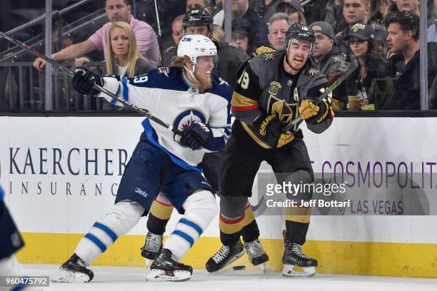 Patrik Laine of the Winnipeg Jets checks Reilly Smith of the Vegas Golden Knights in Game Four of the Western Conference Final during the 2018 NHL...