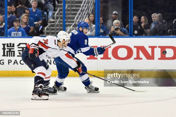 Tampa Bay Lightning center Tyler Johnson takes a shot on his backhand while defended by Washington Capitals defender John Carlson during the first...