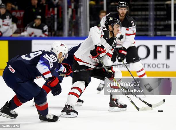 Cam Atkinson of the United States and Connor McDavid of Canada battle for the puck during the 2018 IIHF Ice Hockey World Championship Bronze Medal...