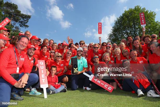 Adrian Otaegui of Spain poses with the trophy and the volunteers after beating Benjamin Hebert during their final match to win the tournament on the...