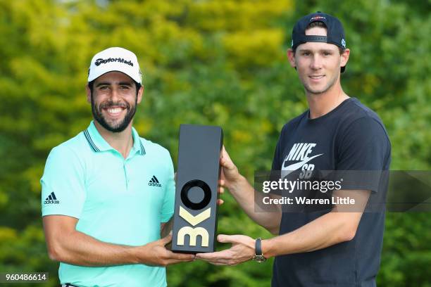 Thomas Pieters of Belgium presents the trophy to Adrian Otaegui of Spain after he beats Benjamin Hebert during their final match to win the...