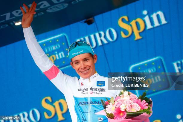 Colombia's rider of team Astana Miguel Angel Lopez celebrates the white jersey of the number one among the junior category on the podium after the...