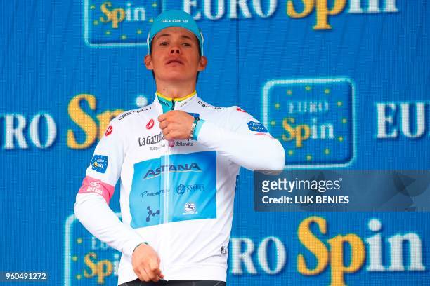 Colombia's rider of team Astana Miguel Angel Lopez celebrates the white jersey of the number one among the junior category on the podium after the...