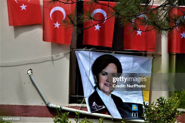 Turkish flags are seen over a portrait picturing Meral Aksener, presidential candidate and the leader of the opposition IYI Party, during a rally in...