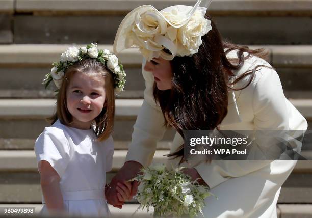 Princess Charlotte of Cambridge stands on the steps with her mother Catherine, Duchess of Cambridge after the wedding of Prince Harry and Ms. Meghan...