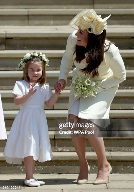 Princess Charlotte of Cambridge stands on the steps with her mother Catherine, Duchess of Cambridge after the wedding of Prince Harry and Ms. Meghan...