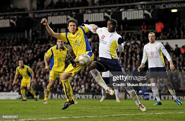 Leigh Bromby of Leeds flicks the ball past Sebastien Bassong of Spurs for teammate Jermaine Beckford to score the goal that levels the scores at 1-1...