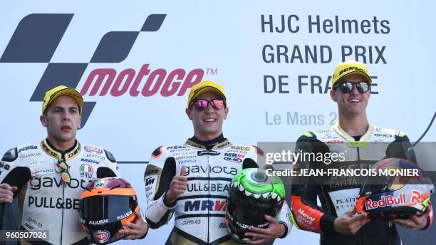 Second placed KTM Angel Nieto Team Moto3 Italian rider Andrea Migno, winner KTM Angel Nieto Team Moto3 Spanish rider Albert Arenas and third placed...