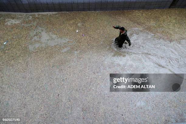 Man walks at the entrance of a flooded underpass following torrential rains in Ankara, on May 20, 2018.