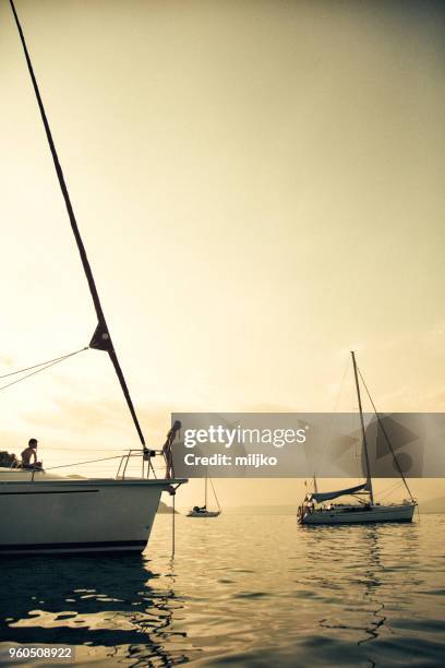 family having a fun on their vacations on sailboat - miljko stock pictures, royalty-free photos & images