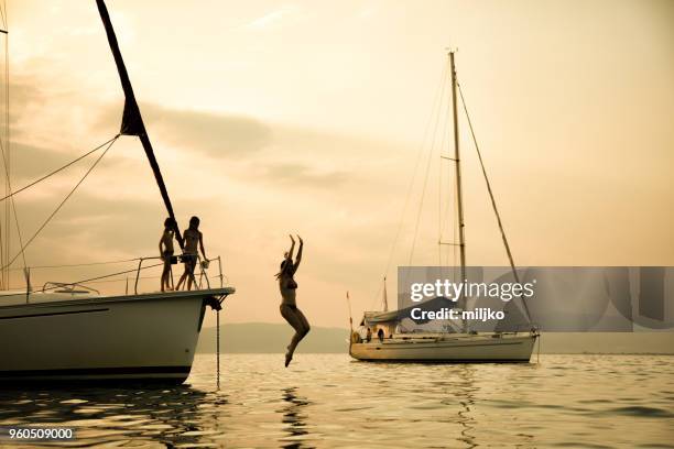 family having a fun on their vacations on sailboat - miljko stock pictures, royalty-free photos & images