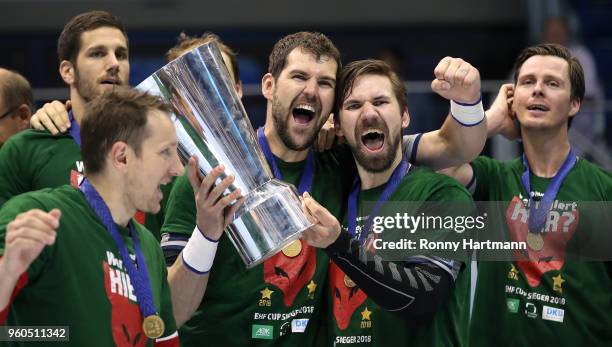 Hans Lindberg, Fabian Wiede, Jakov Gojun, goalkeeper Petr Stochl and Stipe Mandalinic of Fuechse Berlin celebrate with the trophy after winning the...