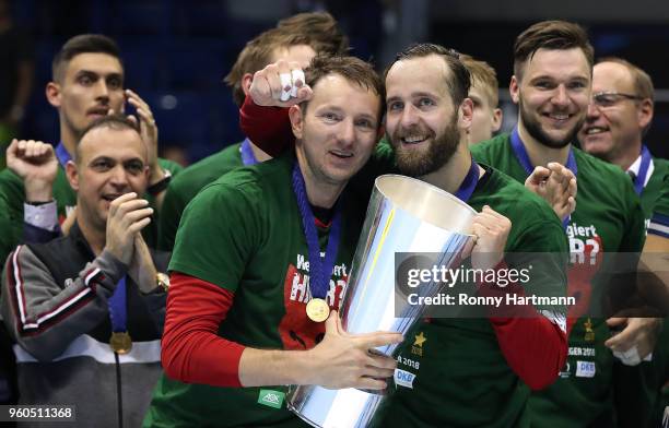 Goalkeeper Silvio Heinevetter and goalkeeper Petr Stochl of Fuechse Berlin celebrate with the trophy after winning the Ottostadt Magdeburg EHF Cup...