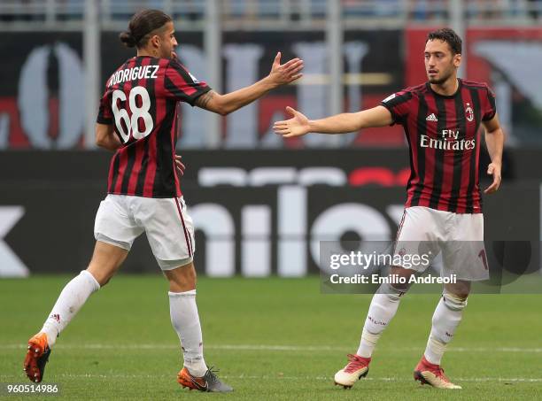 Hakan Calhanoglu of AC Milan celebrates his goal with his team-mate Ricardo Rodriguez during the serie A match between AC Milan and ACF Fiorentina at...