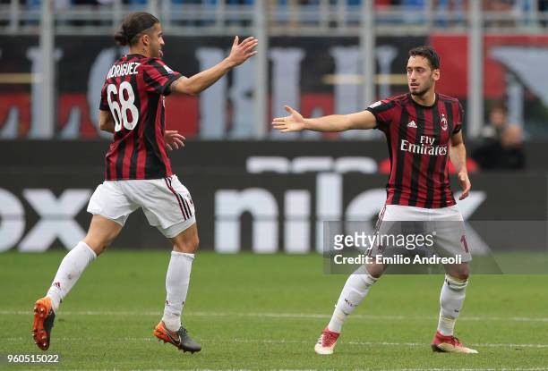Hakan Calhanoglu of AC Milan celebrates his goal with his team-mate Ricardo Rodriguez during the serie A match between AC Milan and ACF Fiorentina at...