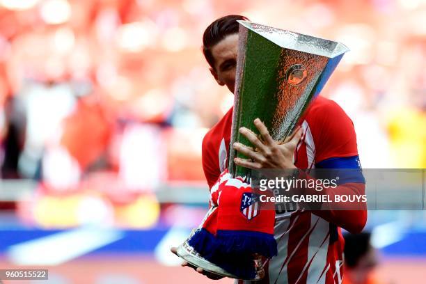 Atletico Madrid's Spanish forward Fernando Torres kisses their Europa League trophy before the Spanish league football match between Club Atletico de...