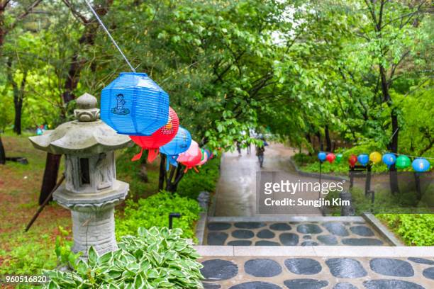 a path with stone lantern decorated with paper lantern - sungjin kim stock pictures, royalty-free photos & images