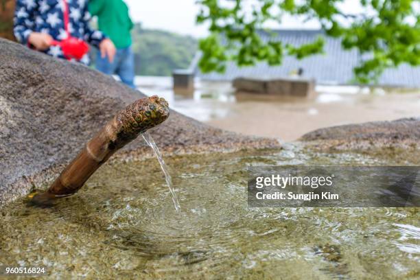 mineral spring at buddhist temple - sungjin kim stock pictures, royalty-free photos & images