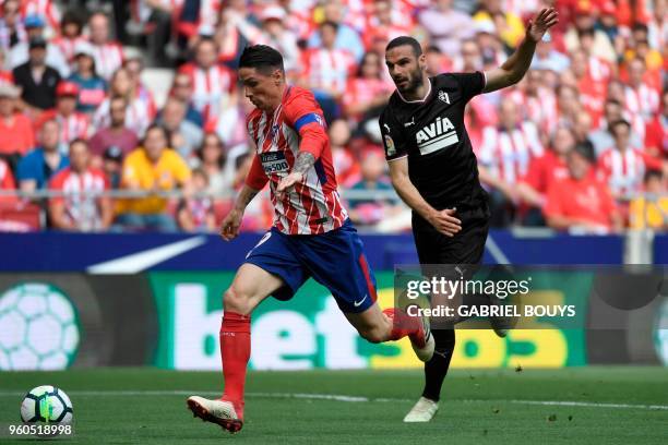 Eibar's Spanish defender David Lomban challenges Atletico Madrid's Spanish forward Fernando Torres during the Spanish league football match between...