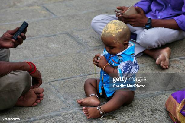 Tamil Hindu child rests after prayers at the Palani Arulmigu Shri Dhandayuthapani temple which is one of the Six Abodes of Murugan. The temple is...