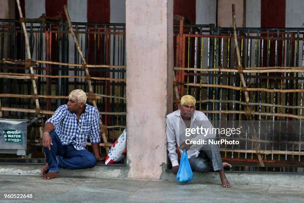 Tamil Hindu devotees rest after completing prayers at the Palani Arulmigu Shri Dhandayuthapani temple which is one of the Six Abodes of Murugan. The...