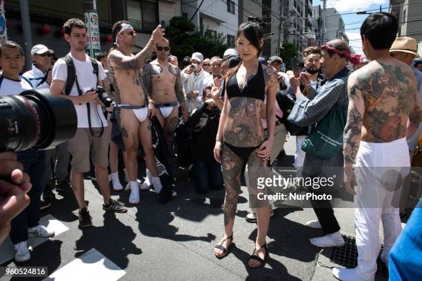 Heavily tattooed Japanese woman pose for photo during Tokyo's one of the largest three day festival called &quot;Sanja Matsuri&quot; on the third and...