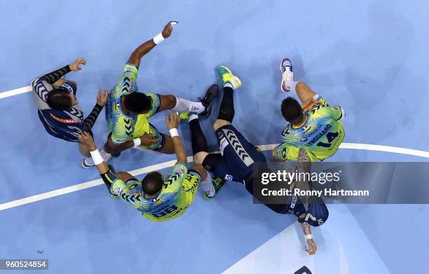 Johan Koch of Fuechse Berlin is attacked by Alexander Lynggaard , Wissem Hmam and Adrien Dipanda of Saint-Raphael next to Fabian Wiede of Fuechse...