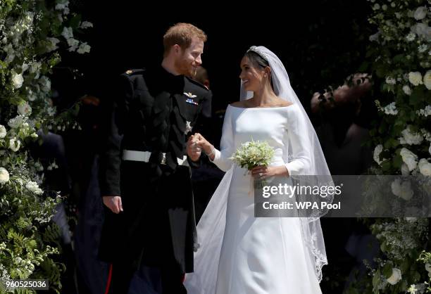 Prince Harry, Duke of Sussex and The Duchess of Sussex share a kiss after their wedding at St George's Chapel at Windsor Castle on May 19, 2018 in...