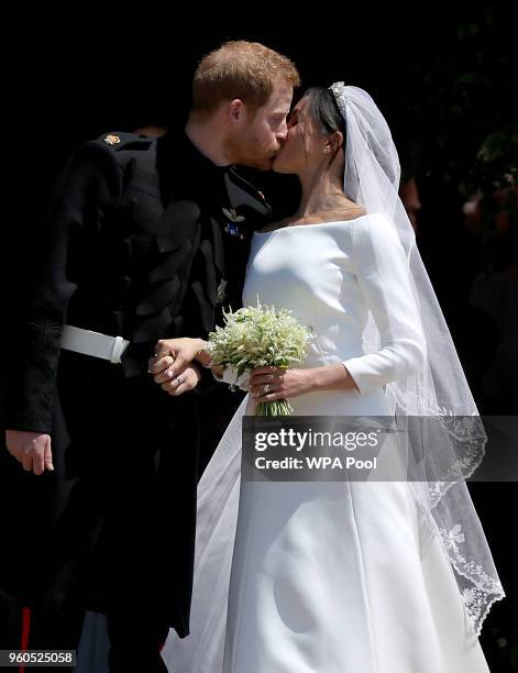 Prince Harry, Duke of Sussex and The Duchess of Sussex share a kiss after their wedding at St George's Chapel at Windsor Castle on May 19, 2018 in...